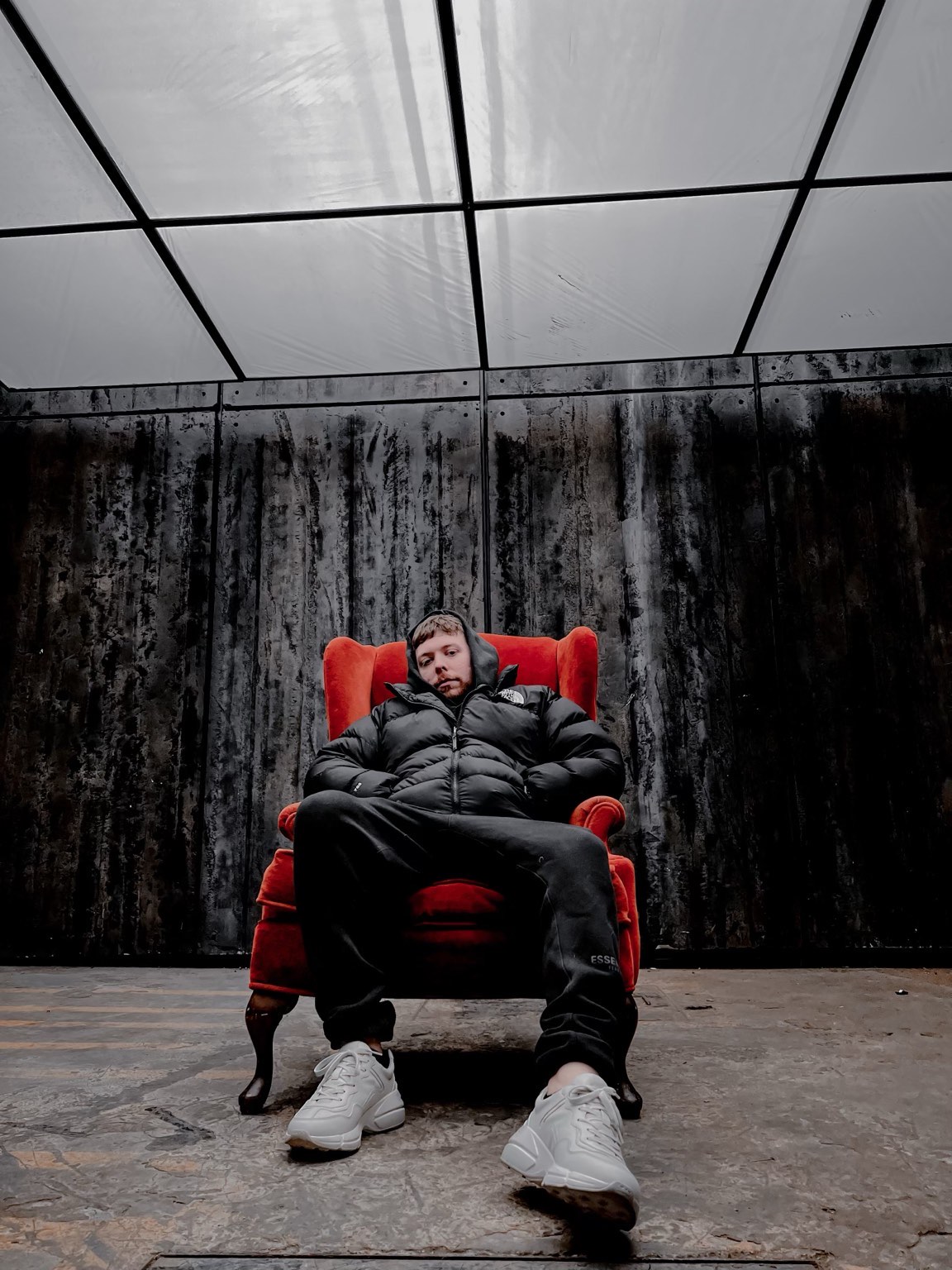 a man is sitting on a red chair